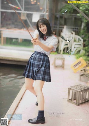 A woman in a school uniform posing for a magazine.