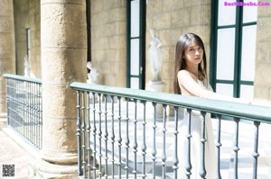 A young ballerina in a black leotard and pointe shoes.