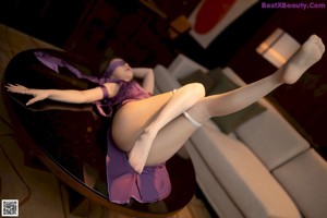A woman in a purple dress sitting on a chair.