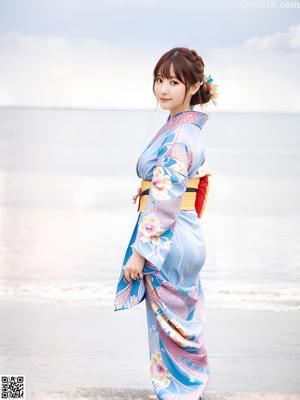 A woman in a purple kimono posing for the camera.