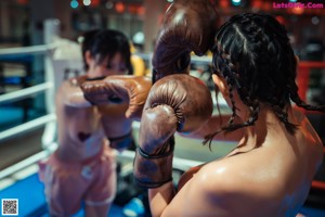 A woman in a boxing ring wearing boxing gloves.