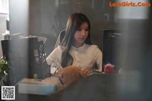 a woman sitting at a desk in an office