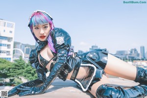 A woman in fishnet stockings and high heels posing for a picture.