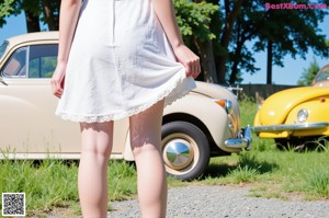 a woman in a white top and thigh high socks posing for a picture