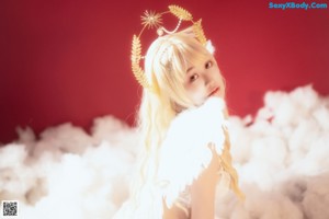 A woman in a white lingerie laying on a cloud.
